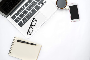 top view of White office desk table with a lot of things on it.