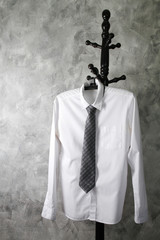 White shirt with long sleeves and necktie on grunge background.