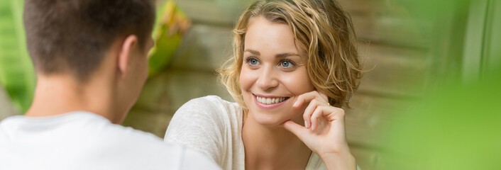 Fototapeta premium young couple sitting at a table and speaking
