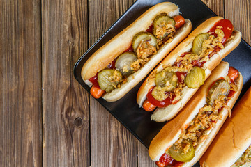 American hot dog with pickles,onions, ketchup and mustard