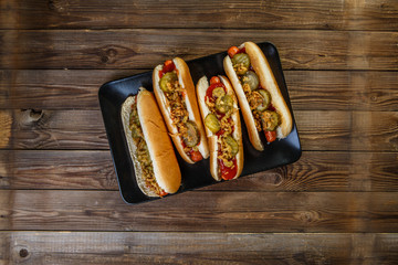 American hot dog with pickles,onions, ketchup and mustard