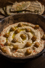Homemade Chickpea Hummus in Rustic Bowl with Olive Oil and Fresh Pita Bread
