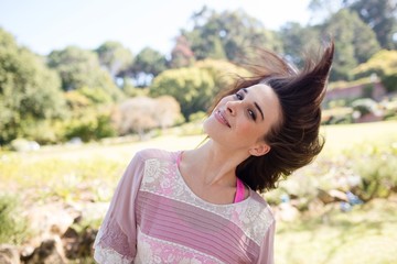 Fototapeta premium Woman swaying her hair in park