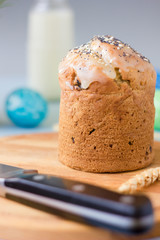Easter cake standing on easter table, served by easter eggs milk and flowers.