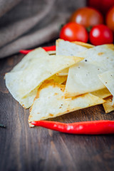 Organic mexican snack - nachos - corn chips with vegetables.