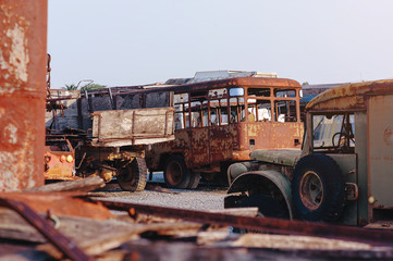 rows of cars in a salvage yard facing each other