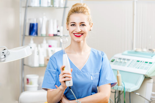 Portrait of female cosmetologist in uniform in the cosmetology office