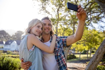 Couple clicking a selfie in park