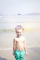 cute little boy with diving glasses at the beach