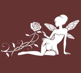 Фея сидит возле цветка