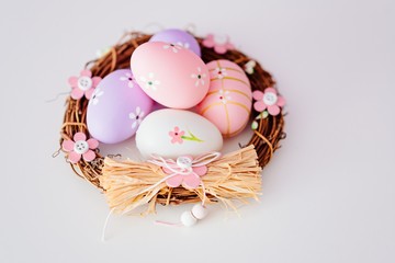 Easter eggs in nest on white background