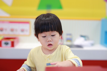 Little girl playing pretend as a sale in ice-cream shop