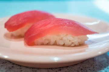 Tuna sushi - rice with fresh tuna on dish, japanese food (soft focus)