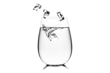 Glass of water with ice cubes on white background.