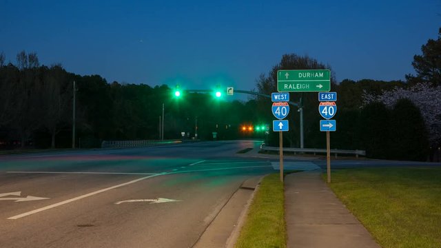 Raleigh Durham NC Interstate 40 Traffic Timelapse at Exit Interchange with Fast Moving Vehicles Passing East West Roadside Direction Signage 