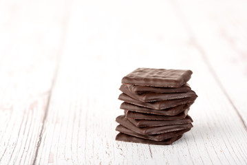 Chocolate bar on white wooden table