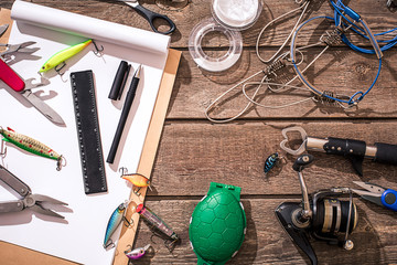Accessories for fishing on the background of wood. Top view