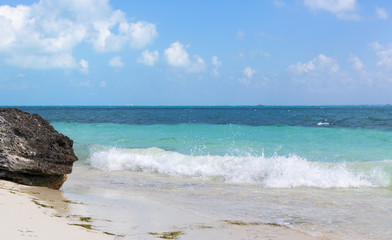 The Caribbean sea and the white sand beach.