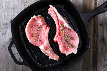 Raw steaks in grill pan ready to cook