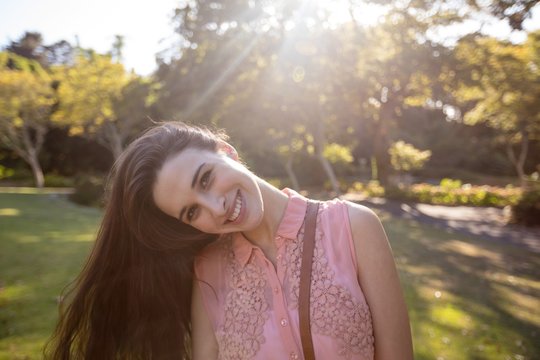 Portrait Of Beautiful Woman Swaying Her Hair In The Park