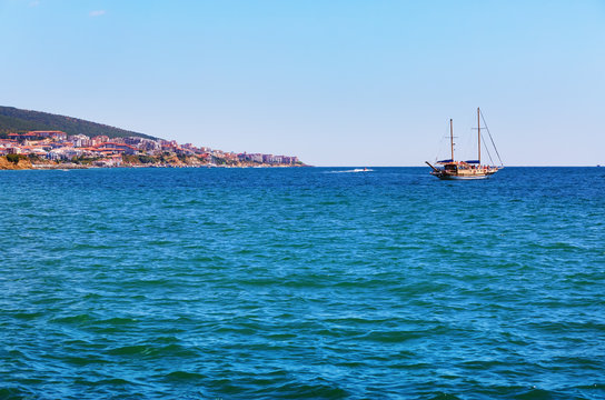 Fototapeta Picturesque seascape. Black Sea coast. Pleasure yacht and shore on the horizon.