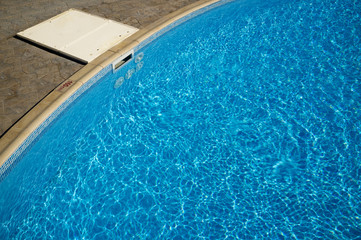 Cleaning water filter in swimming pool.