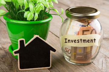 Real estate finance concept - money glass with investment word