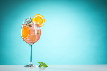 The rose exotic cocktail and fruit on blue