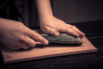 Fototapeta premium Chef cutting the fish on a board