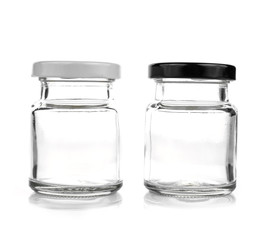 Empty glass jar with aluminum lid over white background