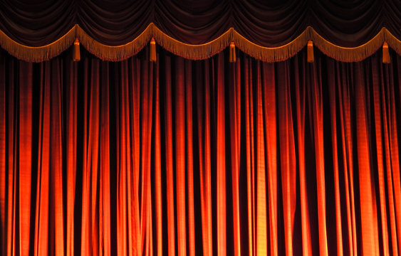 Red curtain on the stage of theatre