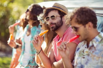 Group of friends eating ice lolly