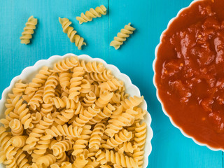 Bowl of Uncooked Fusilli Pasta With Chopped Tomatoes