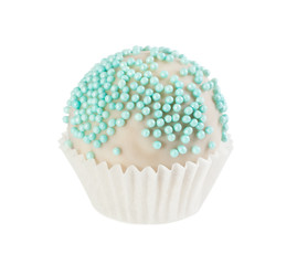 Cake ball in white glaze with blue sprinkles in paper form
