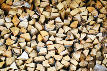 Natural wooden background, closeup of chopped firewood. Firewood stacked and prepared for winter Pile of wood logs. Chopped firewood on a stack.