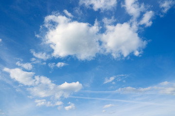 Naklejka na ściany i meble White clouds in the blue sky. Cloudscape over horizon. Heaven.