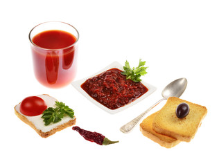 Homemade tomato chutney in a bowl of tomato juice in a glass isolated on white background
