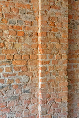 Angle view of old empty uneven raw brick wall with pillar © illusoryreality