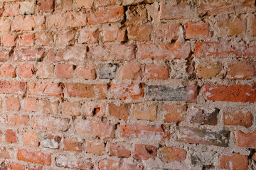 Angle view of old empty uneven raw brick wall