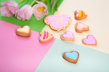 Colorful cookies in heart-shapes on a color background
