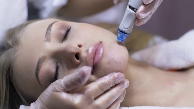 Woman having a water clean skin treatment in a skincare clinic