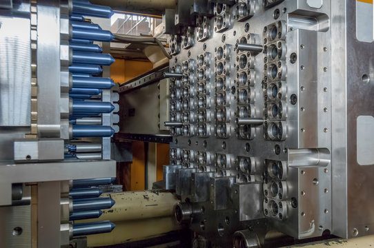 equipment for the manufacture of preforms for plastic bottles. PET production. press machine produces flasks for plastic bottles