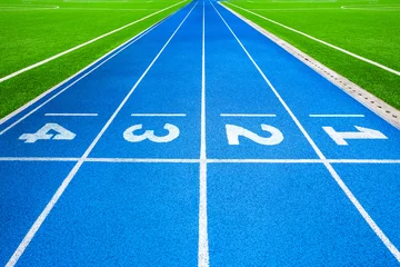 Tuinposter Athletics stadium running track blue lines marks. © funfunphoto