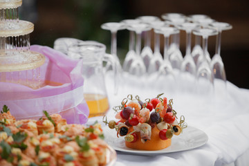 glasses with champagne. catering banquet table. a lot of snacks and canapes