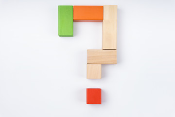 Wooden cube with question mark on white background. Concept for confusion, question or solution.