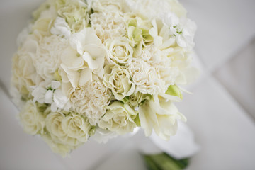 Wedding bouquet made of white roses on a white background