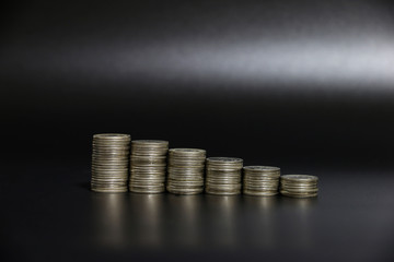 coin on stack on the black desk in the studio,business saving money to profitability