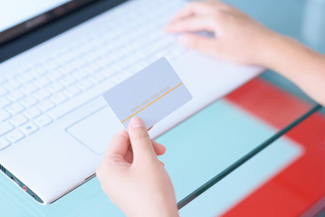 Fototapeta na wymiar Using credit card paying online with laptop.