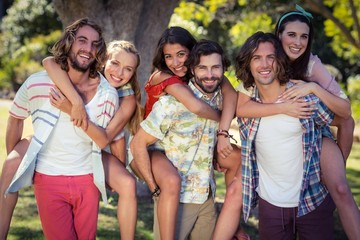 Men giving piggyback rides to women