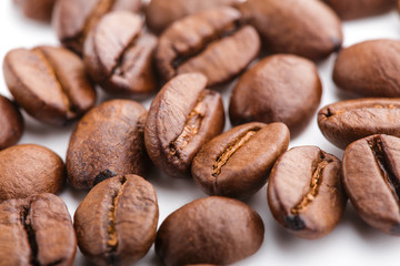 roasted coffee beans isolated in white background. Roasted coffee beans background close up. Coffee beans pile from top on white background with copy space for text. Good morning.